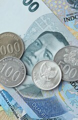 Indonesian rupiah money bills and coins on table. Indonesia cash of IDR currency © Larysa