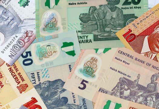 Nigerian naira money banknotes bunch on table. Nigeria bills of NGN currency close up
