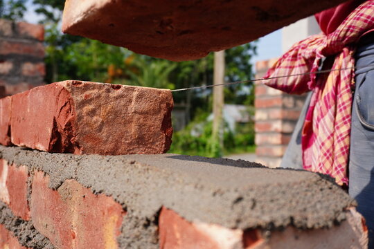 Bricklaying Process with Red Brick and Wet Cement Mortar