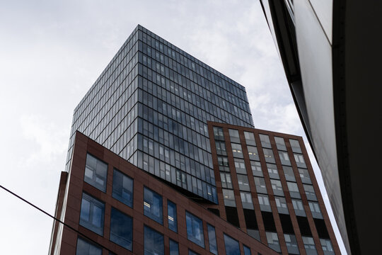 View of a modern skyscraper with a glass facade and geometric window patterns under an overcast sky in Vienna, Vienna, Austria.