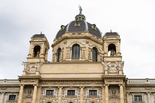 View of the ornate dome and classical facade of the Natural History Museum under an overcast sky in Vienna, Vienna, Austria.