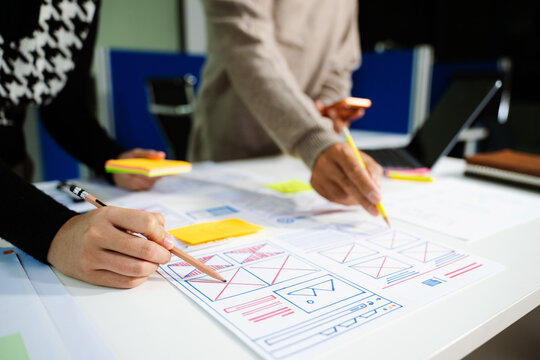  UX developer and ui designer brainstorming about mobile app interface wireframe design with customer breif and color code
