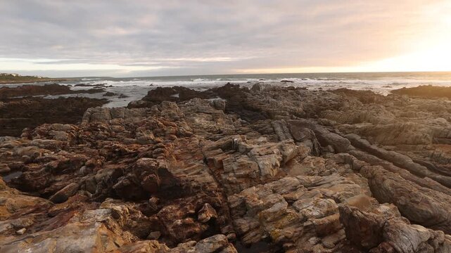 sunset light over rocky coastline of DeKelders, Gansbaai, South Africa