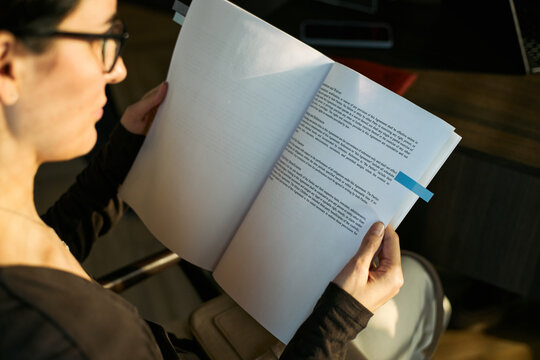 Caucasian middle aged woman reviewing legal documents, handling divorce paperwork and reading contract terms. Useful for family law, separation process, legal services marketing