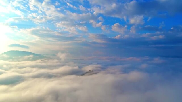 Bright sunlight over endless clouds and mountain horizon in 4K