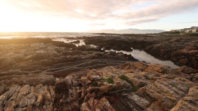 sunset light over rocky coastline of DeKelders, Gansbaai, South Africa