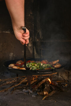 Traditional Valencian paella cooking in wood fired oven