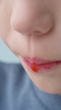 Close shot of a child tasting a sweet summer berry. Natural flavors stimulate taste buds and encourage healthy eating habits from a young age.&nbsp;
