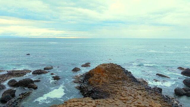 Overhead 60FPS 4K aerial reveal of The Giant's Causeway and Atlantic Ocean in Bushmills, County Antrim in Northern Ireland. Produced with Rec709 color in 3840x2160.