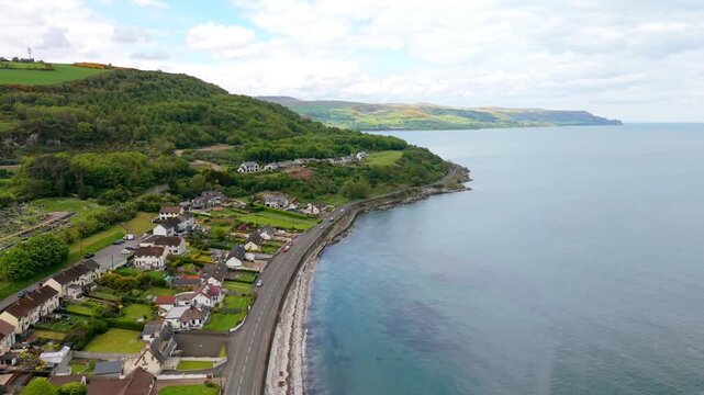 Travelling 4K 60FPS aerial video of the coastal road in Glenarm, County Antrim, Northern Ireland in the UK. Produced in 3840x2160 and with Rec709 color.