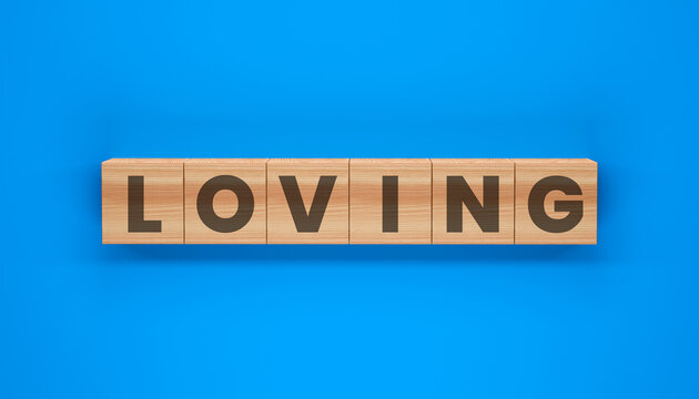 Word Puzzle: LOVING spelled out on wooden blocks, set against a solid blue background. A simple yet powerful image promoting feelings of endearment, affection, and care. 