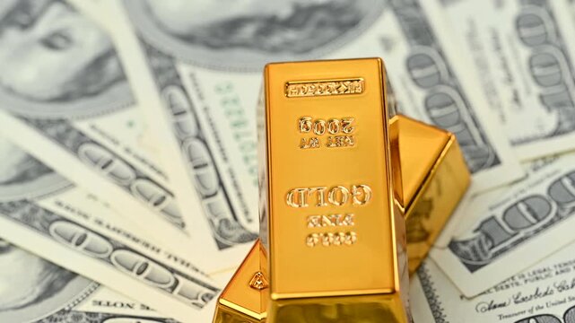 gold bars with dollar bills