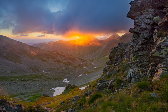 View of Smutne sedlo in Western Tatras with a dramatic sunset over mountain peaks and rocky slopes in Ziar, Zilina Region, Slovakia.