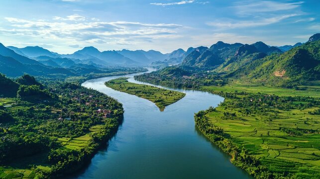 A wide river peacefully divides two lush green valleys, with narrow bridges connecting small villages on either side under a bright blue sky