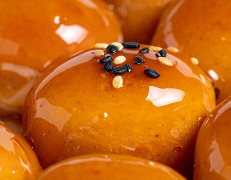 Close-up mitarashi glaze texture, glossy soy caramel detail, no people