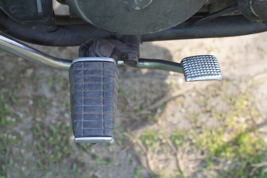 One black plastic metal footrest on a motorcycle on a summer street