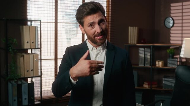 Smiling Caucasian adult business man come here gesture middle-aged male businessman welcoming hand invite looking at camera smile executive inviting recruitment agent welcome to interview in office