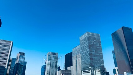 Fototapeta premium Modern Tokyo skyline with office buildings and blue sky in Marunouchi Japan