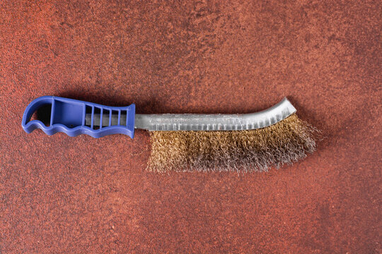 A close-up of a wire brush for cleaning metal items from rust