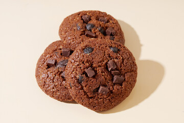 Fototapeta premium Delicious Chocolate Cookies Stacked on a Simple neutral Background for Appealing Dessert Packaging Design