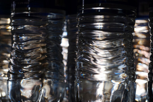 Abstract close-up of plastic water bottle textures with light reflections