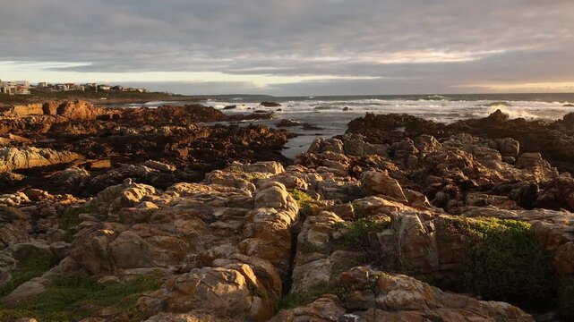 sunset light over rocky coastline of DeKelders, Gansbaai, South Africa