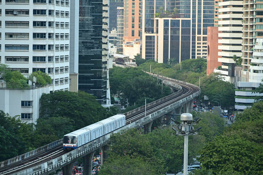 Top view of a BTS Skytrain on elevated rails in Silom district. A Silom Line BTS Skytrain traveling along its  elevated track bed high above busy Ratchadamri Road.