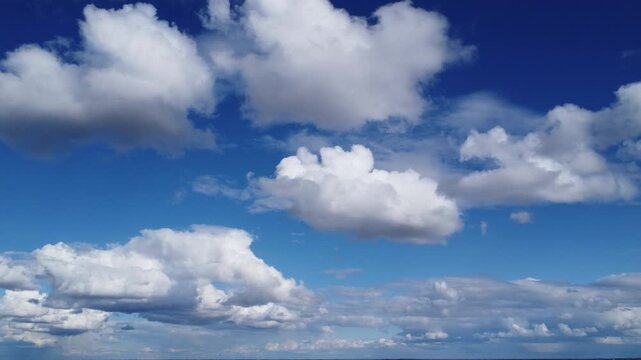 Beautiful 4k sky background with crisp white clouds and copy space, clear blue atmosphere aerial perspective, optimistic weather concept for travel and advertising, natural daylight