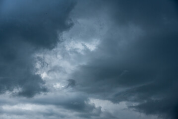 Fototapeta premium Dark cloudscape storm disaster gloomy gray cloud sky. Dramatic dark storm rain clouds black sky background. Meteorology danger windstorm disasters climate. Dark thunderstorm clouds rainny atmosphere