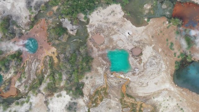 Aerial view of colorful geothermal pools and steam rising from the volcanic landscape of the Danakil Desert Dalol, Afar, Ethiopia.