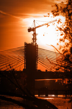 Bridge under construction over the Danube River during a beautiful sunset.