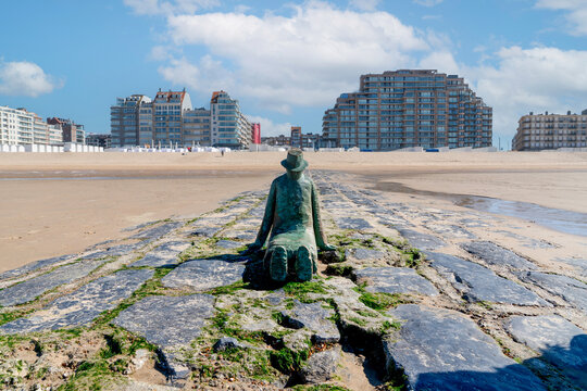 Knokke Heist, Belgium - April 23, 2026: The bronze sculpture "La Mer, ce grand sculpteur" (The Sea, This Great Sculptor) by Jean-Michel Folon on a stone breakwater along the Zeedijk-Knokke promenade