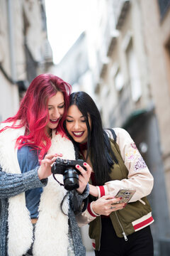 Young Women Friends in Their Twenties Walking Through Night Shopping Street in Jaen Andalusia Spain