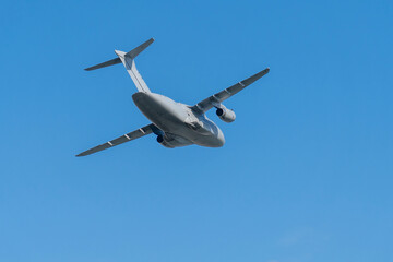 Gray hungarian military transport plane flying in the blue sky © ZenitX