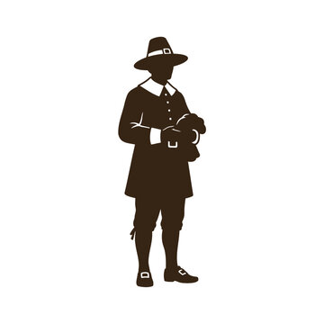 Silhouette of a pilgrim man wearing a traditional hat and colonial clothes standing for thanksgiving celebration