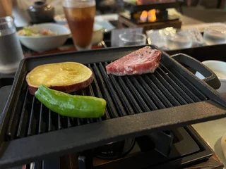 Premium Japanese wagyu beef grilling on cast iron tabletop grill © Stefan