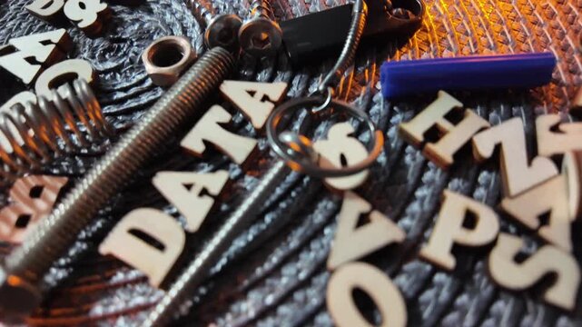 Wooden letters spelling DATA and HOOPS scattered with hardware