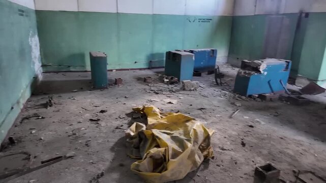 Abandoned elevator machine room with ruined equipment in old building