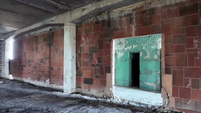 Panning shot of an abandoned industrial interior with tiled walls and doorways