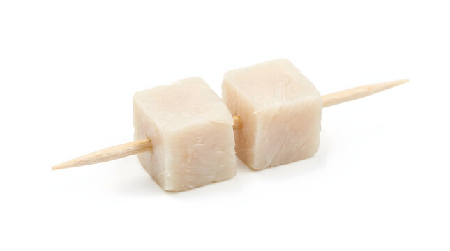 Cubes of traditional Icelandic fermented shark meat on a toothpick, isolated on a pure white background