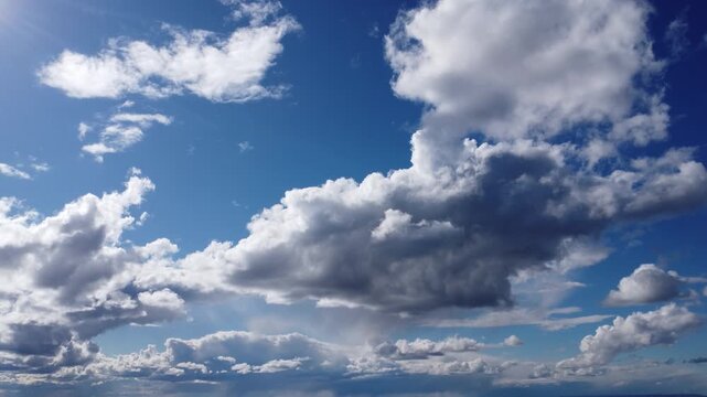 4K aerial drone view of dramatic white and grey cumulus clouds in a deep blue sky, cinematic high altitude flight, beautiful cloudscape background, bright sunny day with natural lighting, panoramic at
