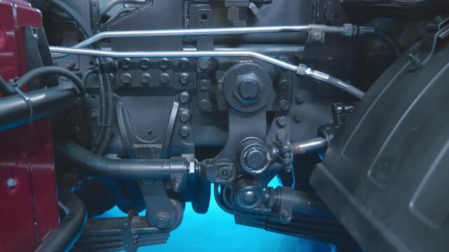 Powerful hydraulic cylinders control additional equipment on the truck. Closeup. Shot in motion