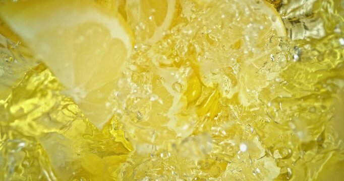 Super slow motion 1000fps video of fresh lemon slices falling into rippling water, creating a sparkling splash, perfect for drink, cocktail and summer visuals.