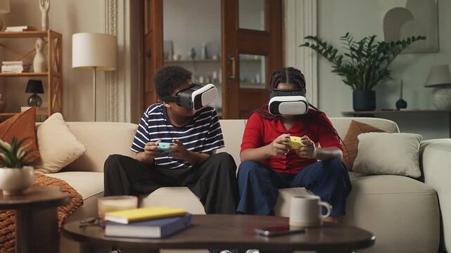 Joyful Black children in VR headsets playing online video game with controllers