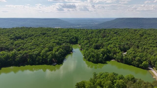 Drone Aerial Looking Down Long Mountain Reservoir Lined with Trees Menlo Georgia