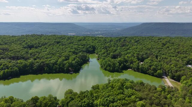 Aerial Drone View of Mountain Lake Community Surrounded by Forest in Menlo Georgia