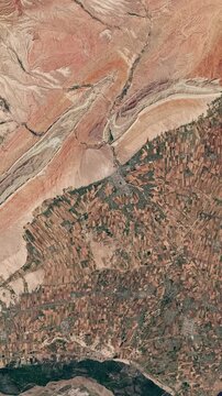 View on agricultural landscape in dry area. Camera is zooming out. Vertical video. Animation based on image by NASA