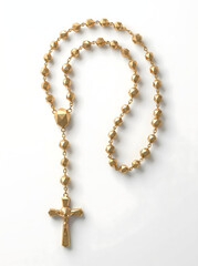 Fototapeta premium gold rosary beads with crucifix on white background