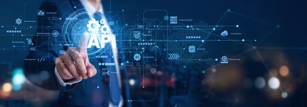 API connects various modular software pieces. A system developer hand touch API icon to sync functions and data. This flexible network bridge is a fundamental software architecture concept.