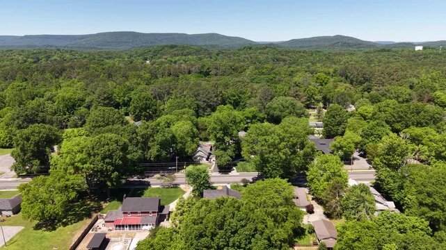 Aerial Drone View of Tree-Lined Main Street Neighborhood with Appalachian Mountains LaFayette Georgia